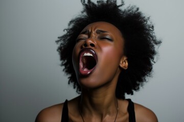Powerful image capturing a young african american woman screaming against a neutral background - Powered by Adobe