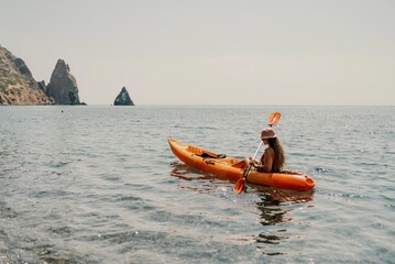 Kayak sea woman. Happy attractive woman with long hair in red swimsuit, swimming on kayak. Summer...