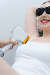 laser epilation, hair removal procedure, young beautiful caucasian smiling woman lying on couch in...