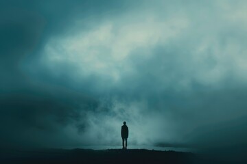 A person standing on a hill under a cloudy sky. Suitable for various outdoor themes