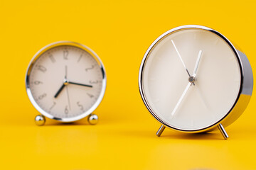 Time and work, the clock stops, the minute hand stops moving, a photo of a clock on a yellow background.