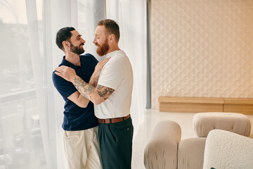 A happy gay couple embraces in a modern living room, dressed in casual clothes, enjoying quality time together.