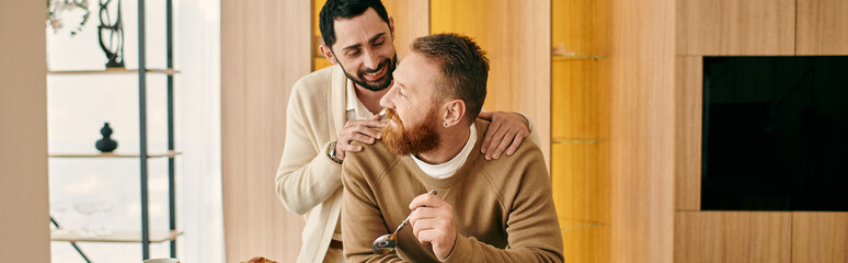 Two men share a warm embrace in a cozy living room, radiating love and happiness.