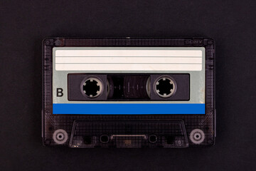Fototapeta premium Retro audio cassette tape from the 80s on a black background.