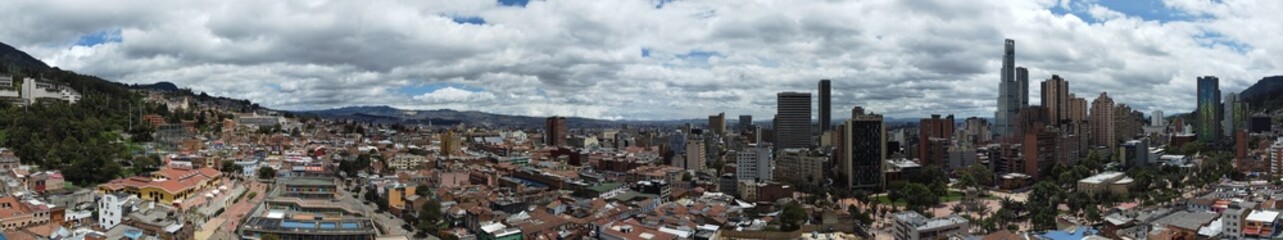 Obraz premium Bogota city in Colombia with skyscrapers and buildings on a cloudy day.