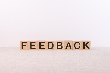 FEEDBACK word made with building blocks on white