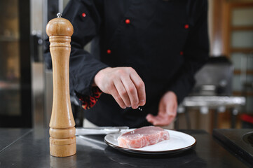Chef cooks pork steak. Recipe book, cooking, restaurant business