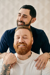 Fototapeta premium A happy gay couple, one with a red beard, sharing a warm hug in a cozy modern living room.