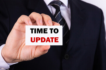 Businessman holding a card with text Time to update