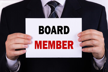 Businessman holding a card with text board member