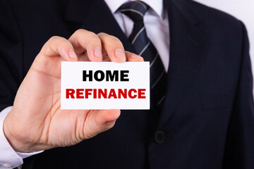 Businessman holding a card with text Home refinance