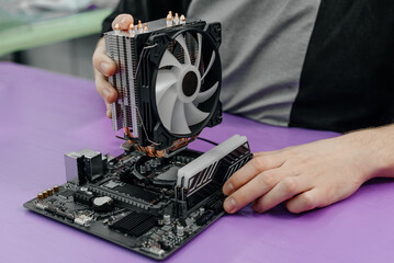 system administrator installing Liquid Computer CPU Cooler Radiator into motherboard, assembling PC of different accessories or components, close-up view of hands, computer repair and maintenance
