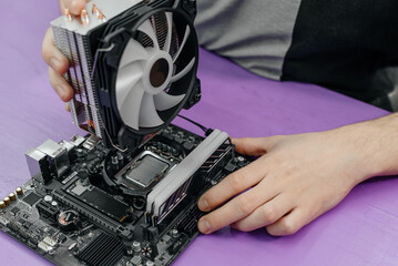system administrator installing Liquid Computer CPU Cooler Radiator into motherboard, assembling PC of different accessories or components, close-up view of hands, computer repair and maintenance