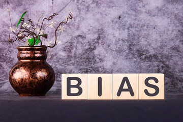 Word BIAS made with wood building blocks on a gray background
