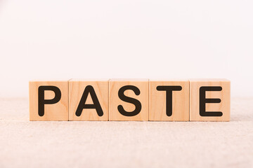 Word PASTE made with wood building blocks on a light background
