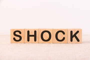 Word SHOCK made with wood building blocks