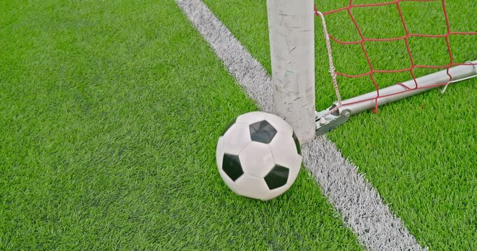 Soccer field impressions - A soccer ball hitting the goal post, missing the goal - Slow-mo