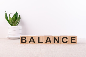 Word Balance is written on wooden cubes blocks on a light background.