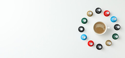 Colored coffee capsules and cup with coffee drink on white background, space for text