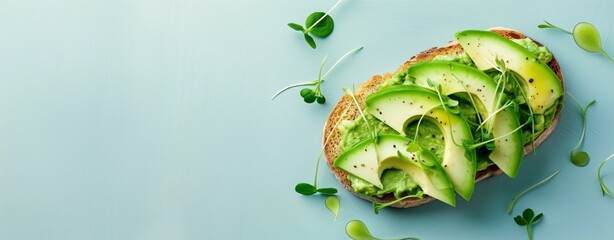 Vibrant image showcasing a healthy avocado toast adorned with slices of ripe avocado and microgreens, presented on a wooden board against a bright blue background, symbolizing clean eating
