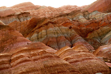 dry desert soil, colorful mountains of China, rock of terracotta shades 