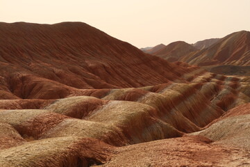 dry desert soil, colorful mountains of China, rock of terracotta shades 