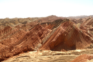 dry desert soil, colorful mountains of China, rock of terracotta shades