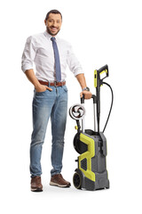 Young man with a high pressure washer machine