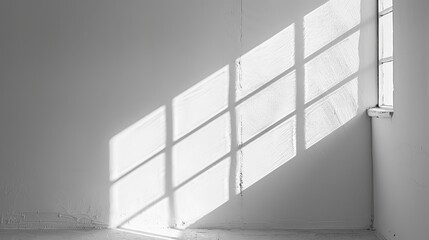 Fototapeta premium The aesthetics of window light shadows on a white minimal wall are very striking