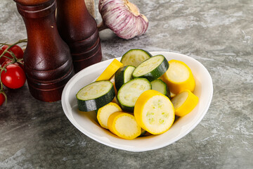 Sliced raw young green and yellow zucchini