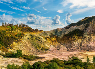 landscape of Plegrean volcano fields in Naples Italy near Pompeii with sulfur yellow caldera duribg eruption of smoke. campi Flegrei and cataclysm of Earthquake