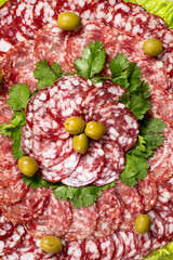 Thinly sliced smoked salami sausage with cilantro and olives