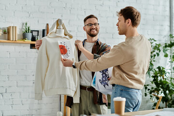 Two designers examine shirt on mannequin in workshop with focus and dedication.