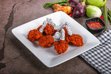 Indian cuisine glazed chicken lollipop