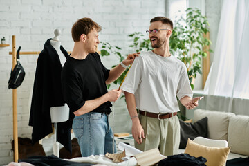 Obraz premium Two men in a designer workshop, working on stylish attire together.