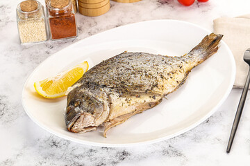 Baked Dorado fish served lemon