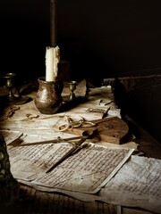 Navigational equipment old map and papers with a candle on a desk of a historical wooden vintage...