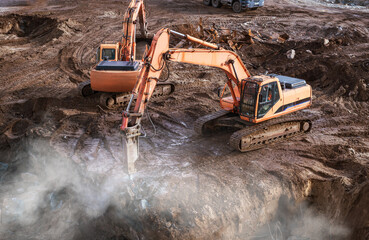 Excavator jackhammer at construction site clearing