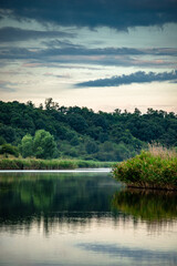 Summer river at morning . Forest on anothe beach. Fog on the water . Green forest . Reflections on the water . Sky over the lake . Trees on beach