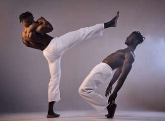Fight, martial arts and black people with kick in studio for karate fitness, action exercise or...