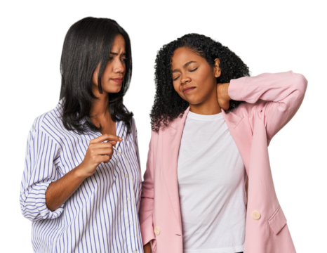Young Latin businesswomen in studio having a neck pain due to stress, massaging and touching it with hand.