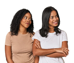 Young Latin friends in studio smiling confident with crossed arms.