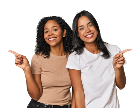 Young Latin friends in studio pointing to different copy spaces, choosing one of them, showing with finger.