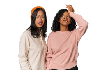 Young Latin friends together in studio forgetting something, slapping forehead with palm and closing eyes.