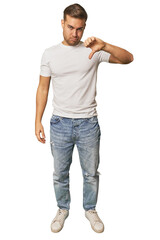 Full body portrait of a man in studio showing thumb down, disappointment concept.