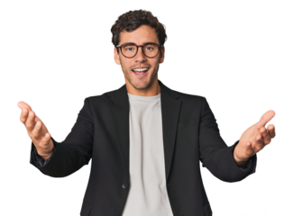 Young Hispanic businessman receiving a pleasant surprise, excited and raising hands.