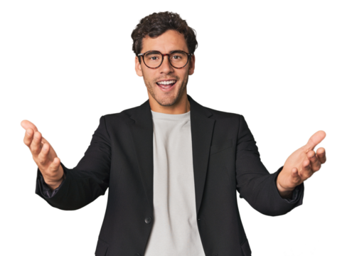 Young Hispanic businessman receiving a pleasant surprise, excited and raising hands.