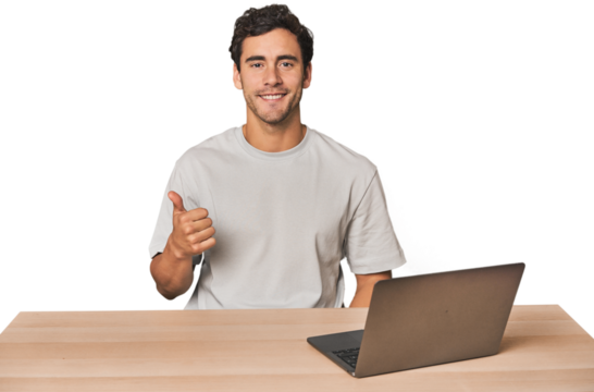 Hispanic young man working on laptop smiling and raising thumb up