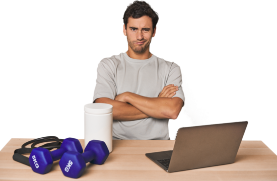 Hispanic trainer planning workout frowning face in displeasure, keeps arms folded.