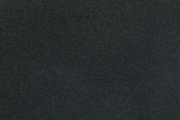 A sheet of black plastic as a background or texture, close-up.